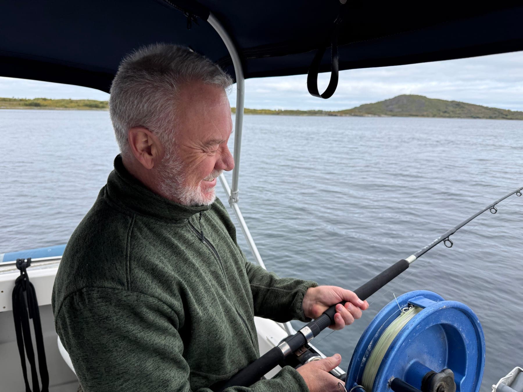 A guest working a rod from the rail as the boat lies off the island