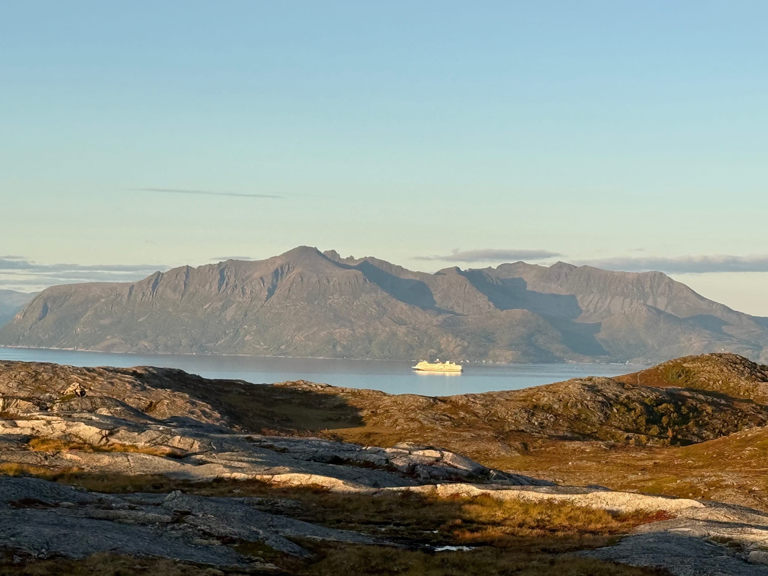 Grytøya across the sound in low evening light, seen from Bjarkøy