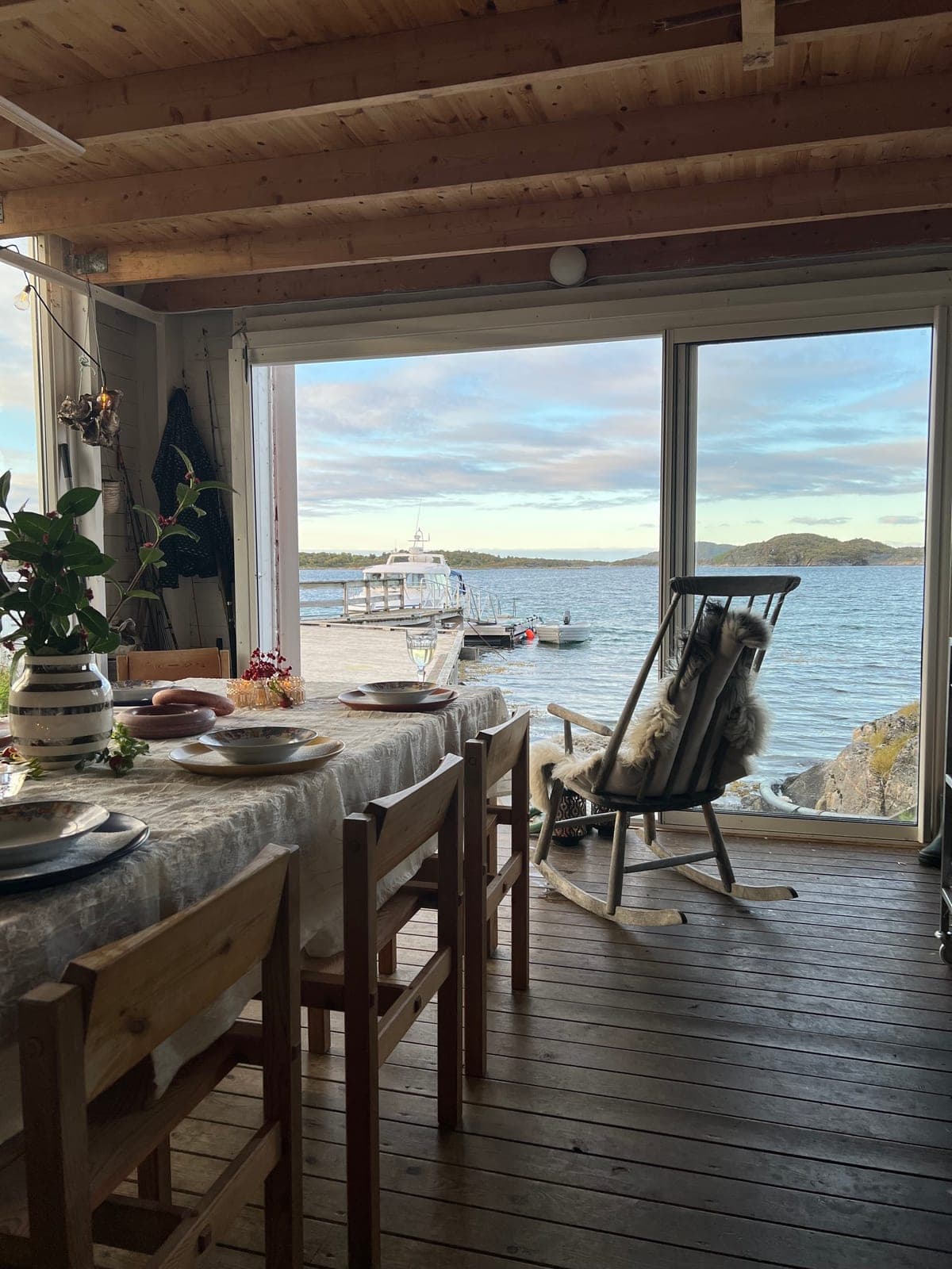 The long table laid in the Sea Lodge, doors open onto the dock and the fjord